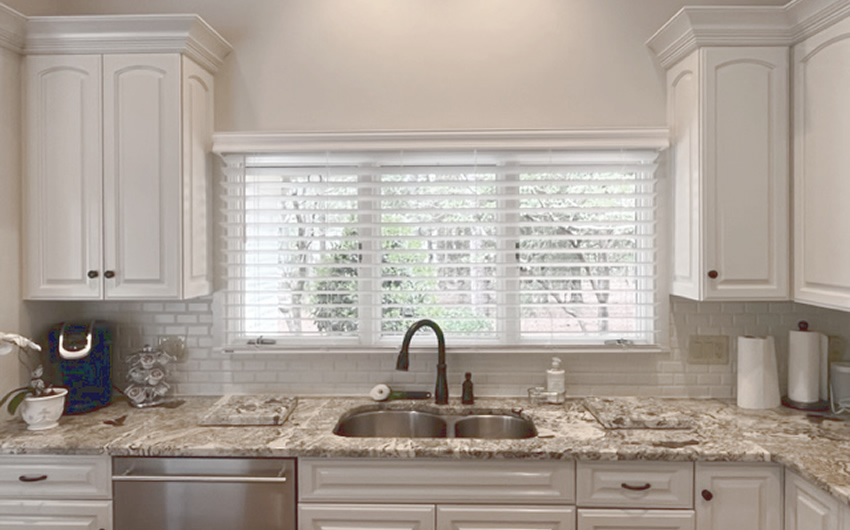 Faux Wood Blinds placed in a kitchen behind a sink