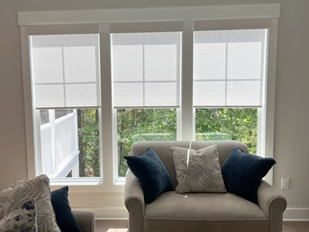 3 Sheer Shades installed on windows behind a confortable chair