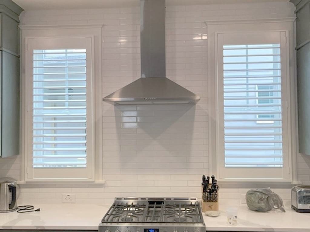 Durable shutters installed over a kitchen sick in a kitchen in North Carolina.