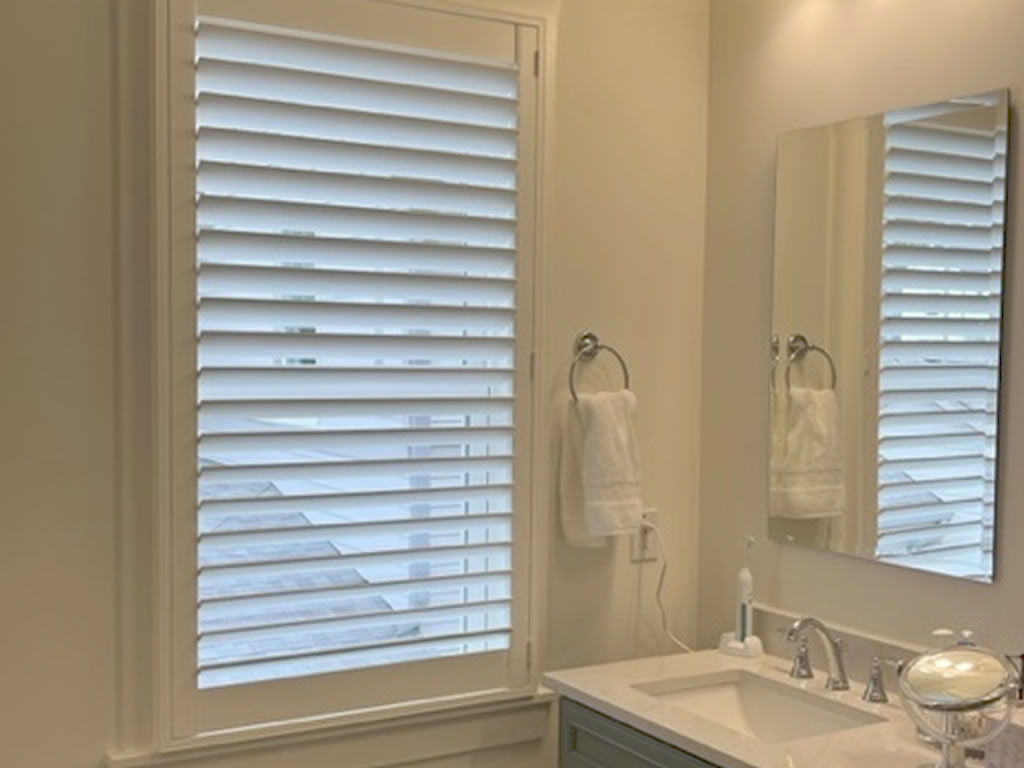 Durable shutters installed next to a sink in a bathroom