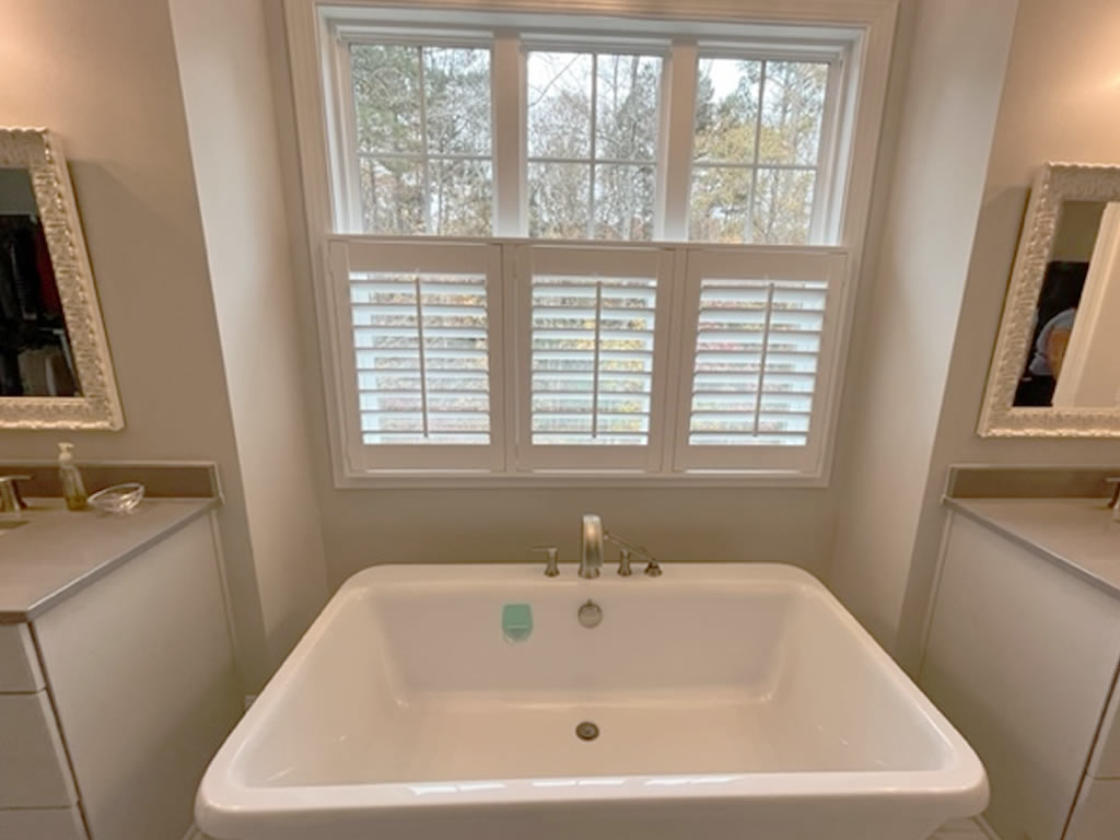 White shutters installed over a sink in a bathroom in North Carolina